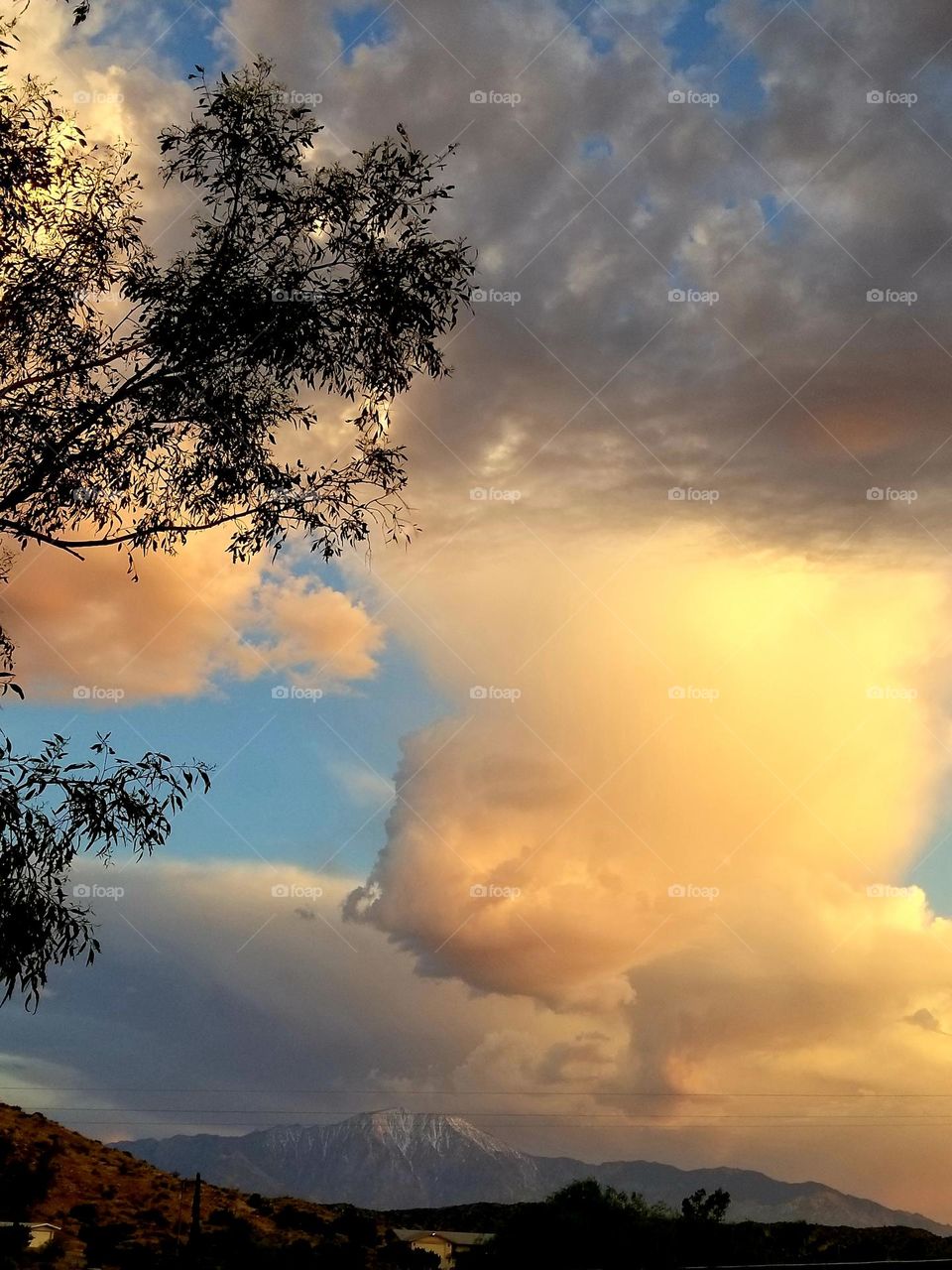 Clouds.
Clouds can dwarf mountains (as seen in the distance here), and can be tinted any color.