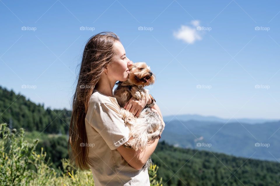 woman and dig hiking in mountains