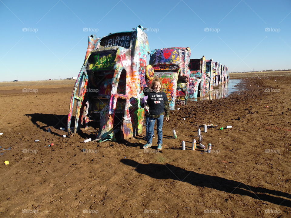 Girl standing near the Cadillac Ranch