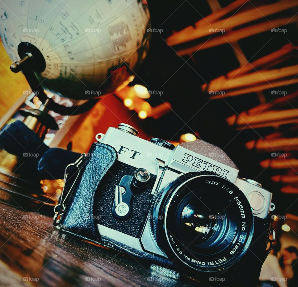 Vintage camera and globe in an adventure themed coffee shop. 