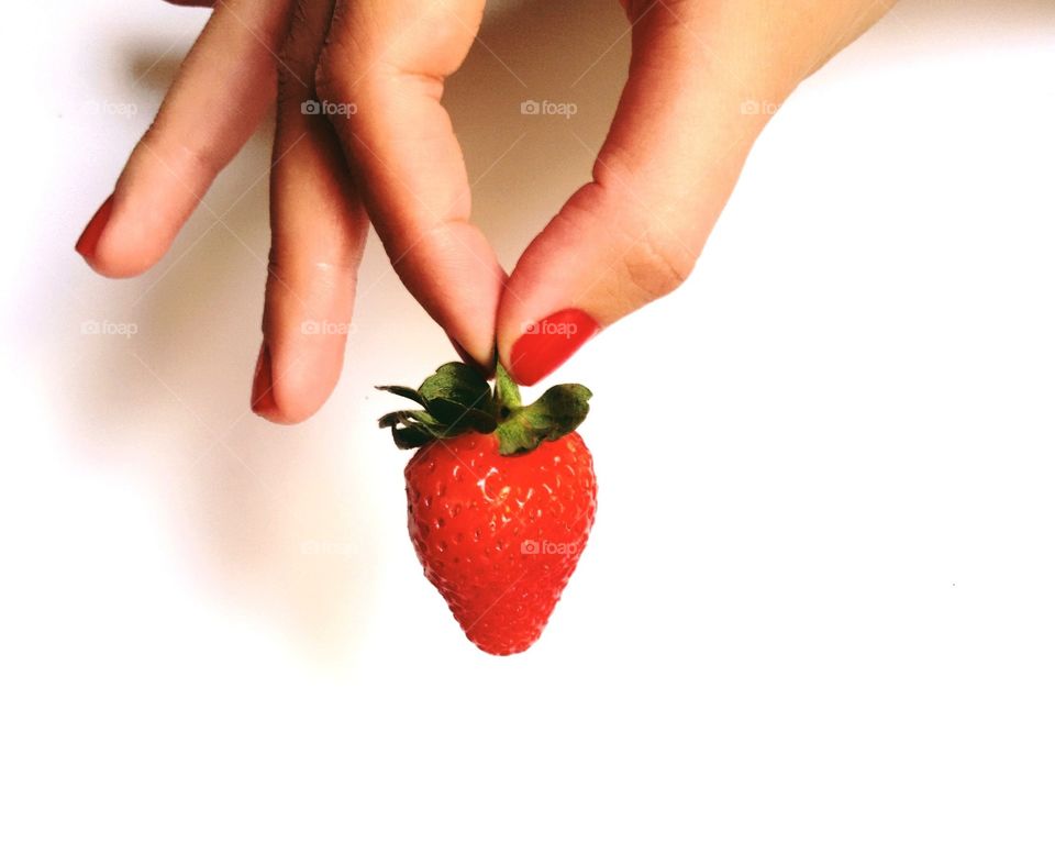 Strawberry holding by women finger