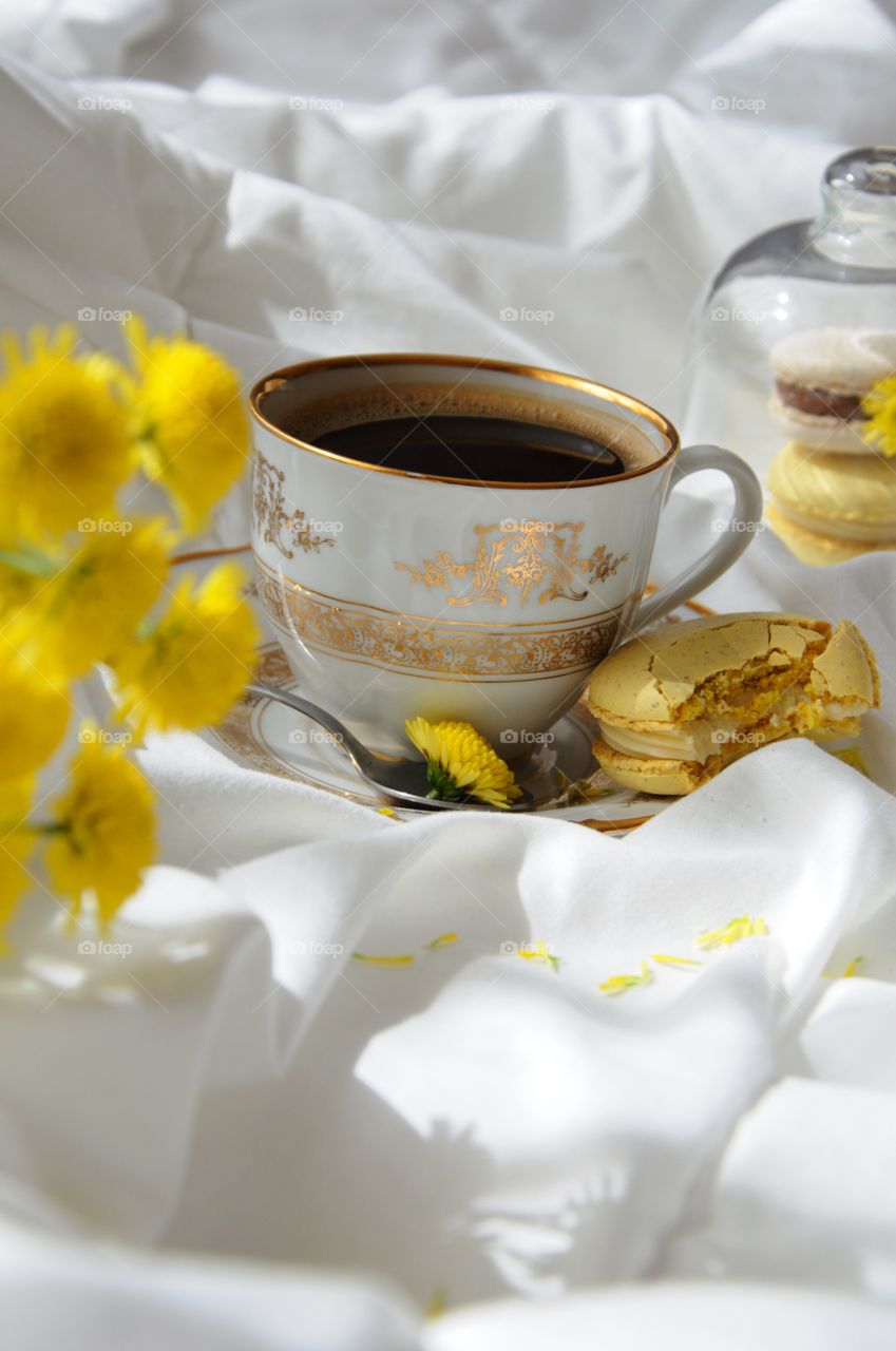 A cup of coffee with French macarons