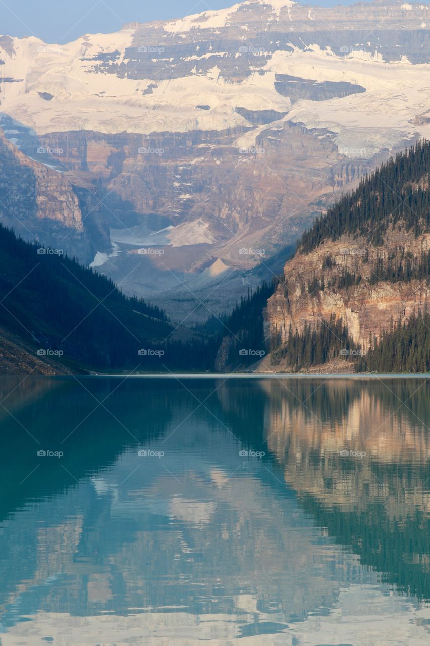 Beautiful postcard quality blue reflective waters of scenic Lake Louise in Banff National Park in Canada's Rocky Mountains. 