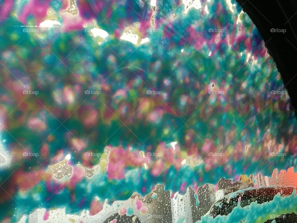 Groovy, colored foam, rainbows on my windshield at the car wash 