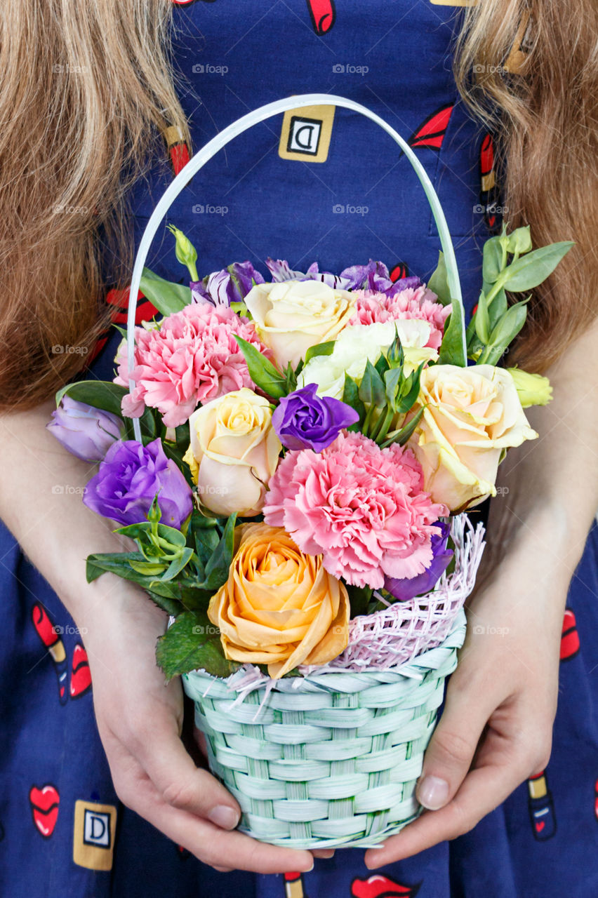 Girl with a basket of flowers