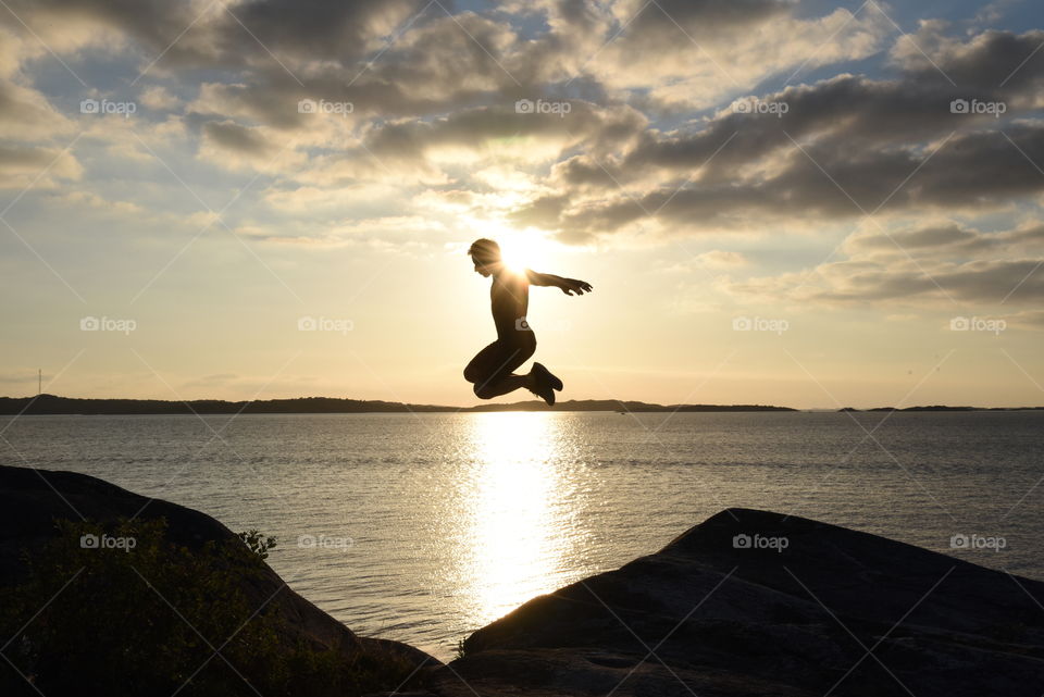Jumping silhouette in front of a scenic sunset