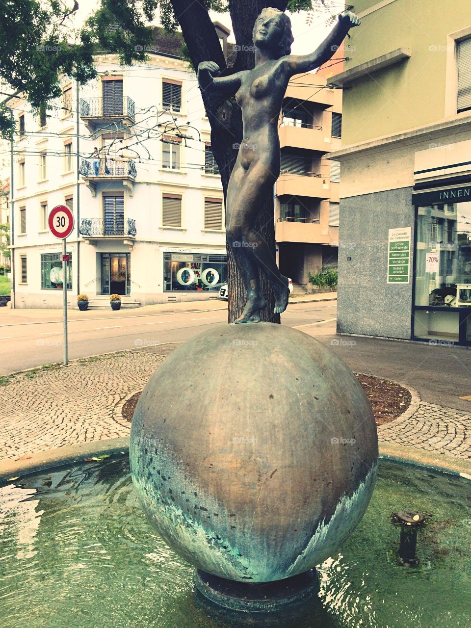 Art Deco statue in metal of naked woman on fountain in town square of Zurich in Switzerland 