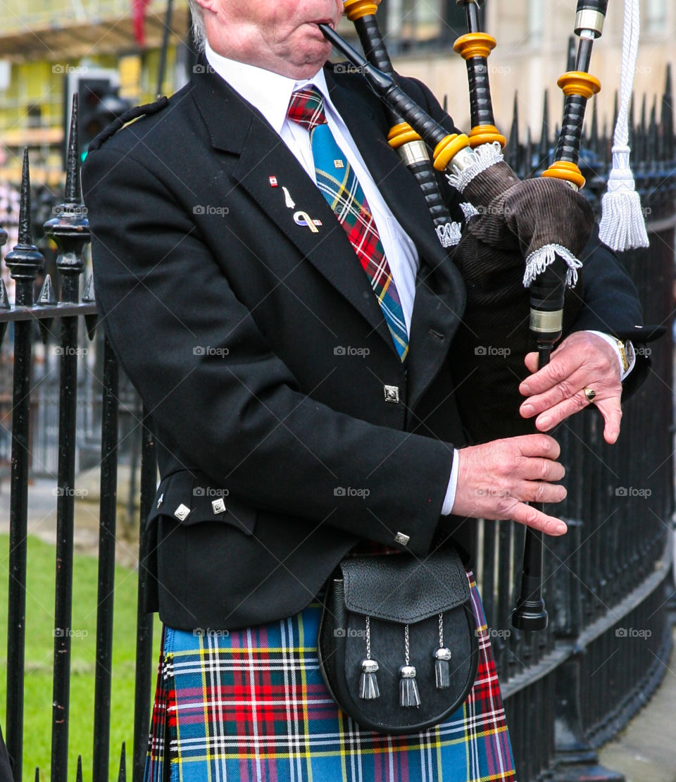 Scot playing bagpipe. 