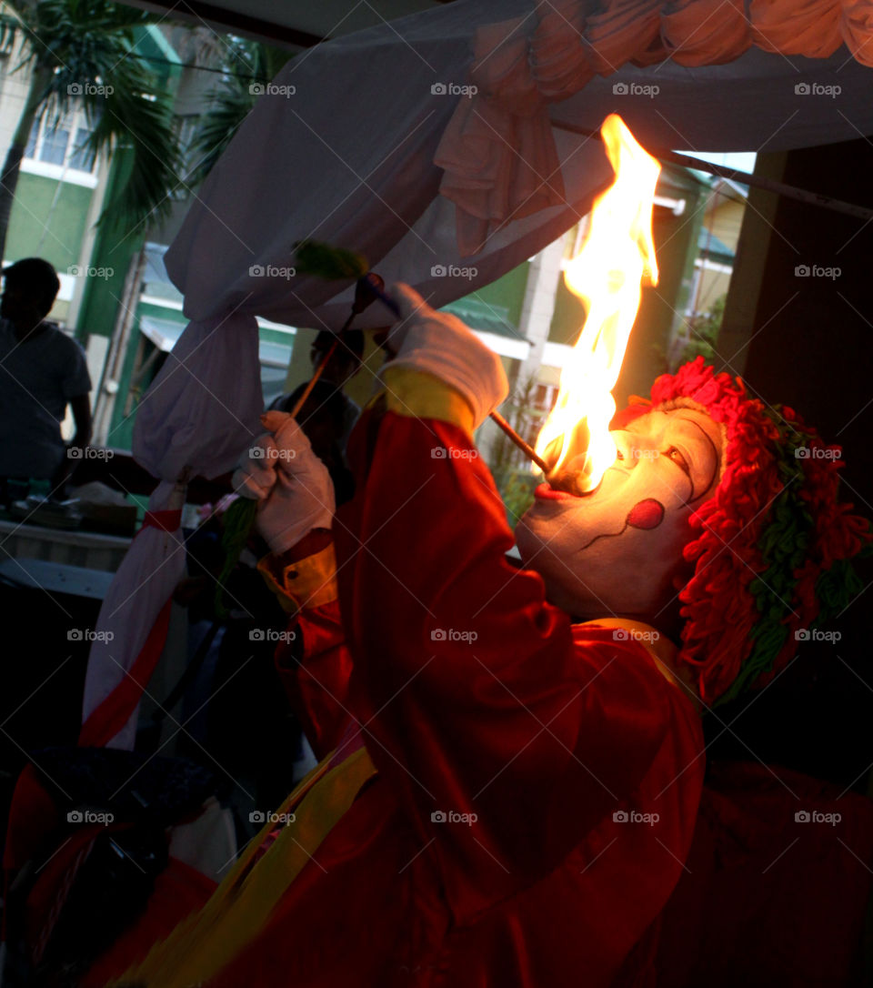 Clown doing fire eating in the event