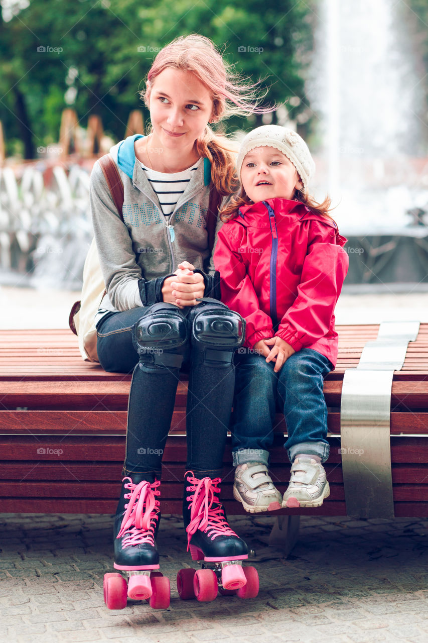 Girl with her sister with skating shoes