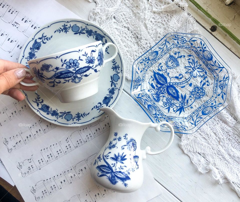 Old porcelain set for bouillon or soup with ornament blue bow