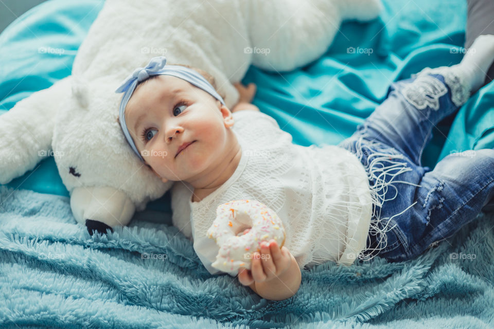 Little girl eating the donuts