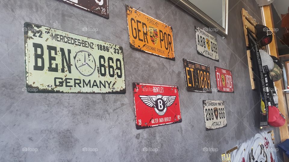Old car license plate made to the wall