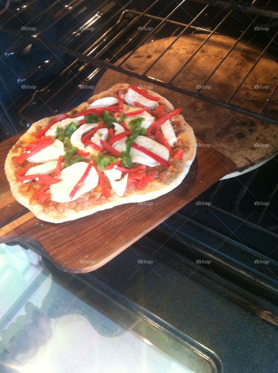 Removing hot pizza from oven