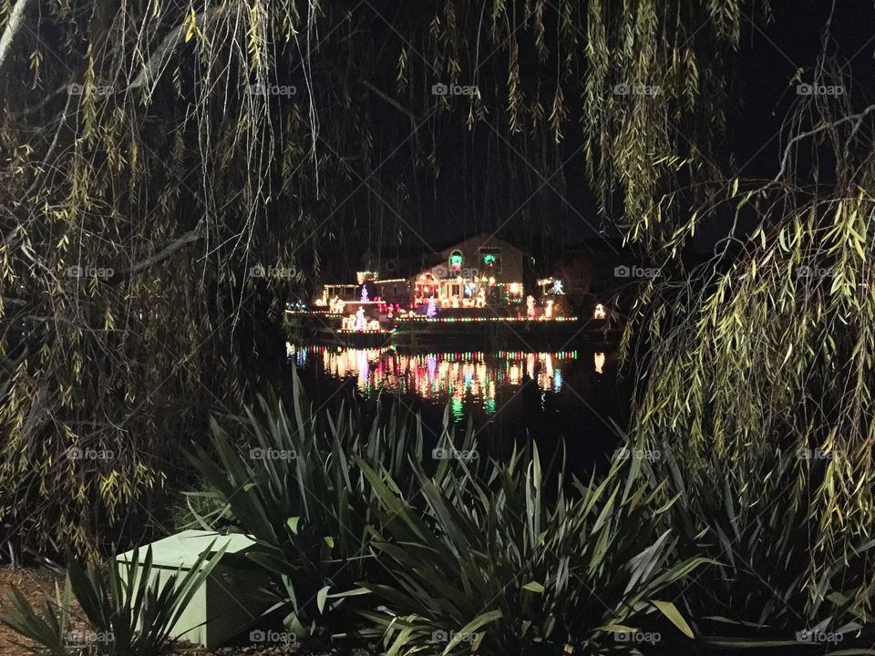 A house is brightly lit for Christmas on the lagoon in Alameda, Calif. 