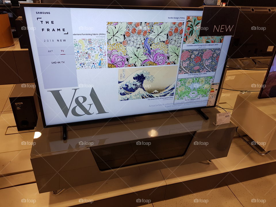 Samsung 49" The Frame art mode 4K Ultra High Definition TV displaying Victoria and Albert gallery showcase displayed on grey and glass TV stand