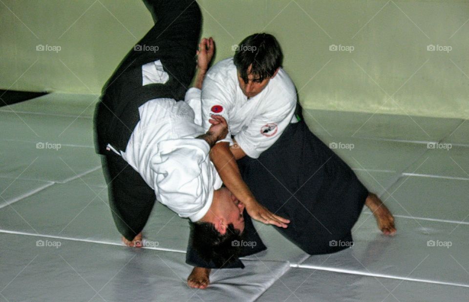 An awsome photo of two men practicing aikido martial arts