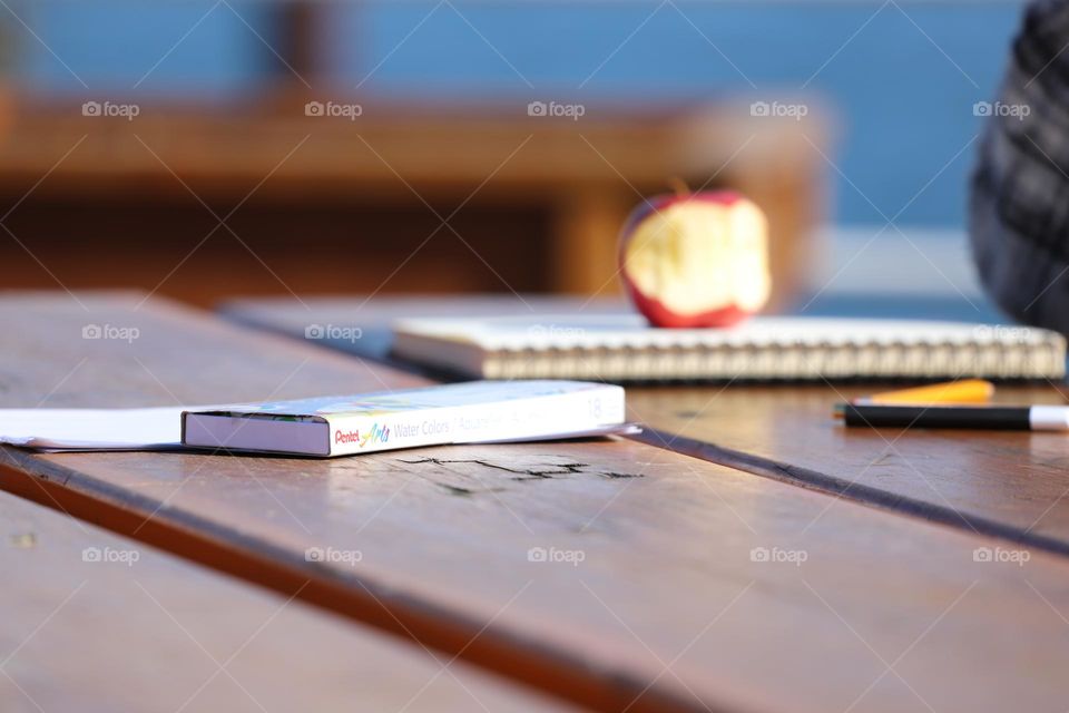 Tabletop with books and apple 