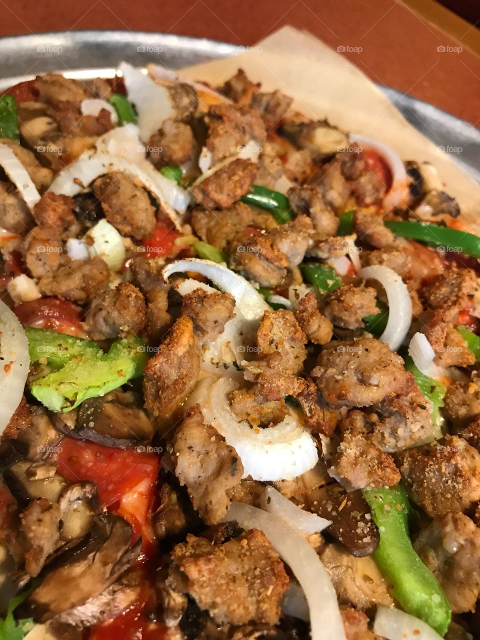 Fresh pizza with sausage onions peppers mushrooms 