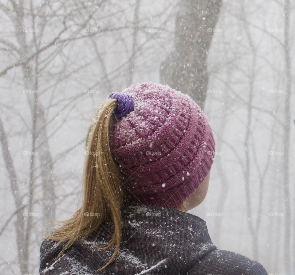 Winter; Woman outdoors enjoying a snow squall