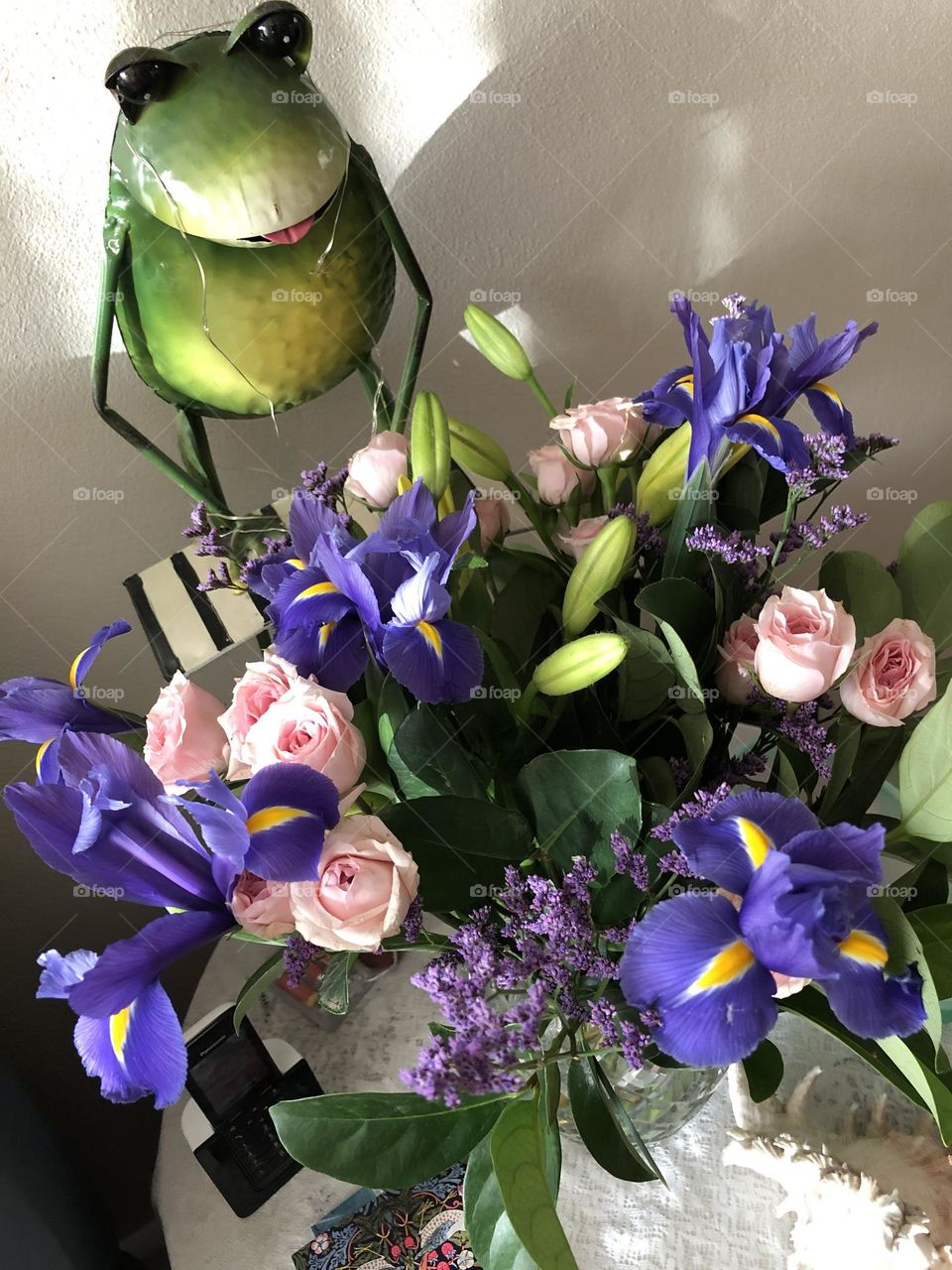 Frog and beautiful flowers make a decorative display in any home