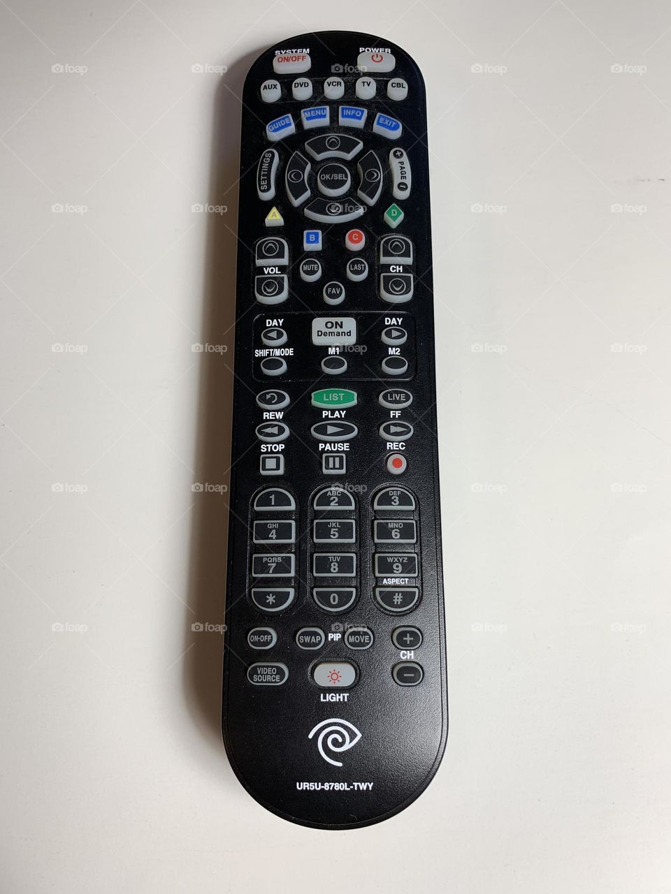 Black remote control against white background.