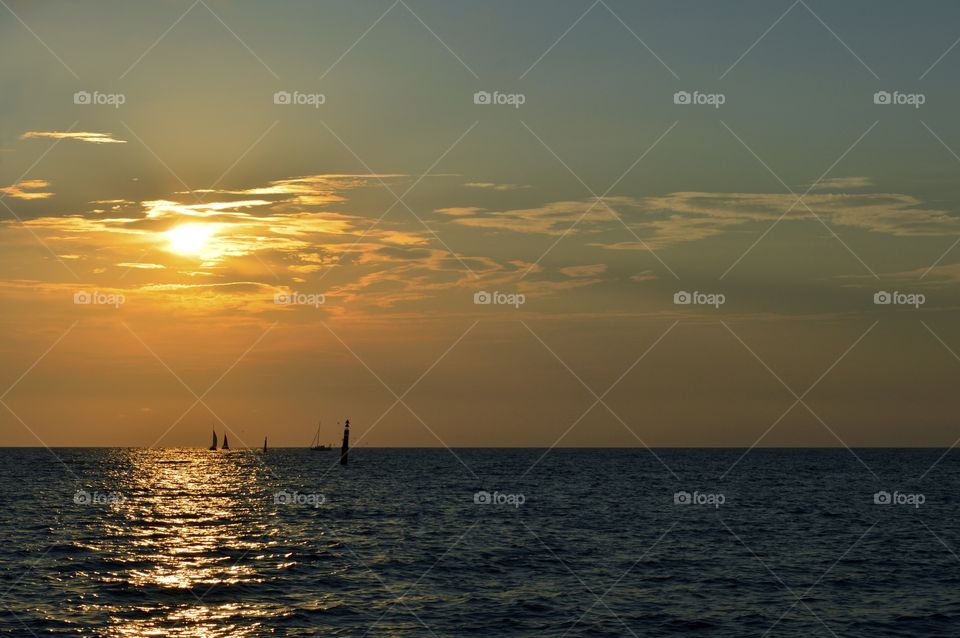 sailboats at sunset in the sea