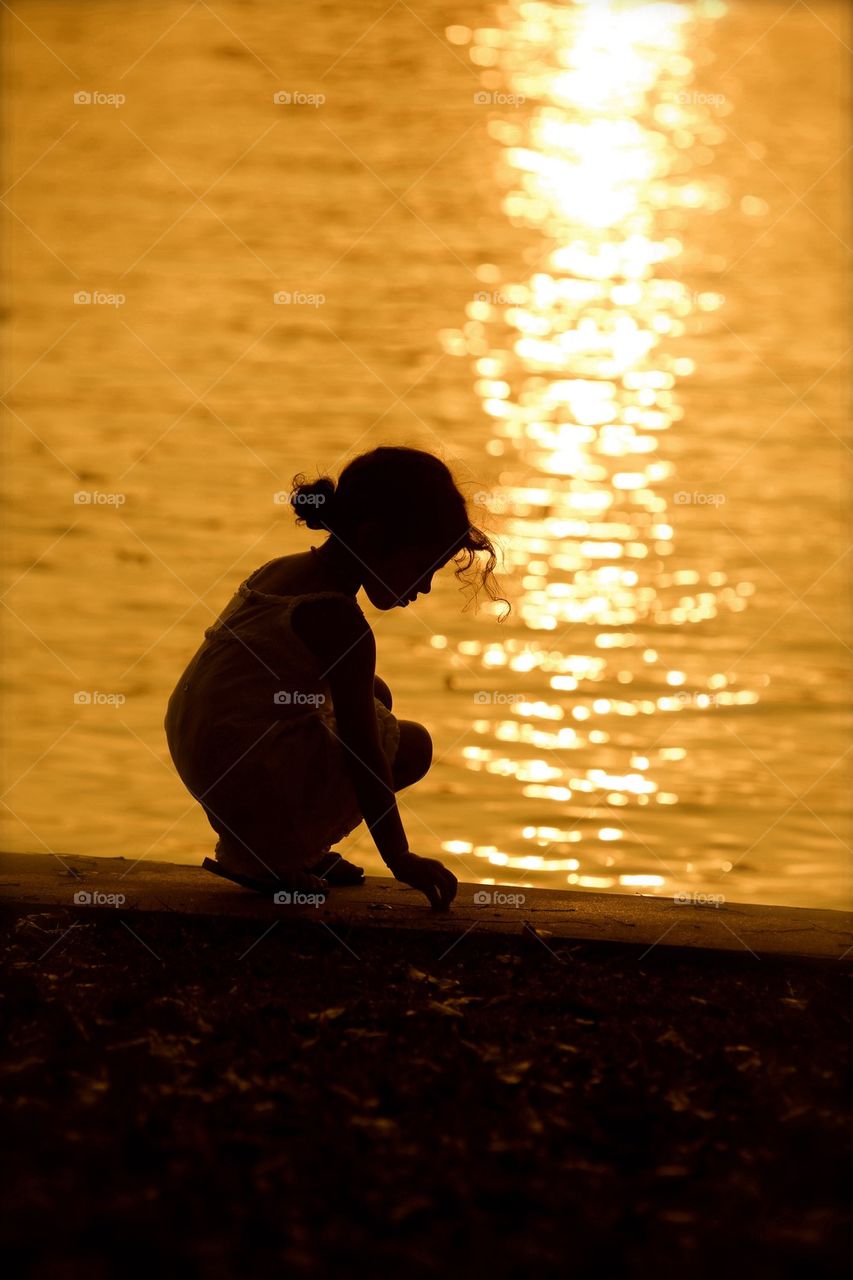 Silhouette of girl near sea