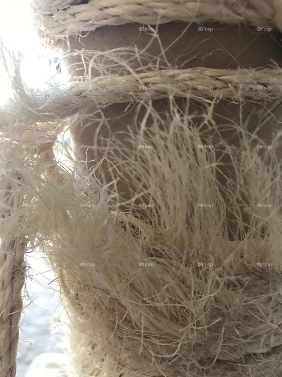 Frayed rope around cat scratcher close up