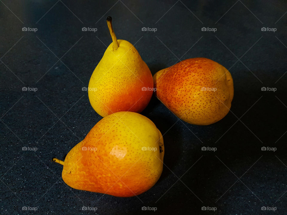 Blush pears on dark background
