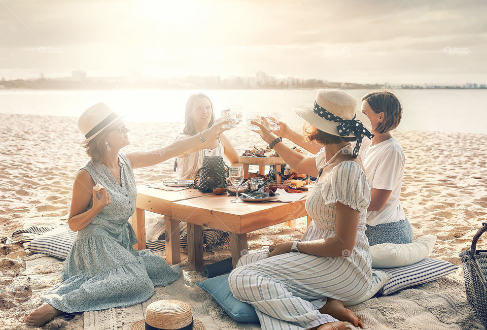 Female friends have picnic on the beach