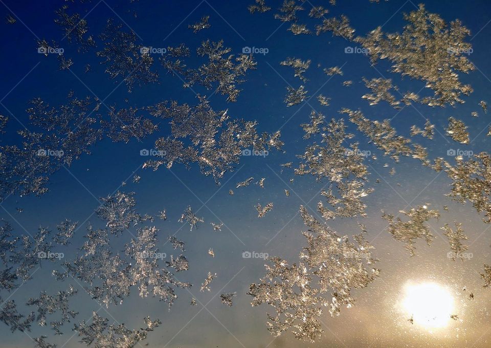 Snowflakes on the background of the sky with the sun❄️ Freezing day❄️☀️