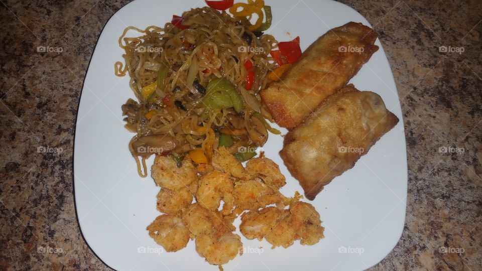 fried shrimp,pan fried noodles with vegetables and egg rolls
