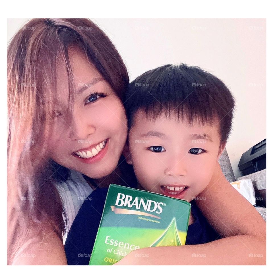 Asian woman and kid with Chicken essence for energy of the day 