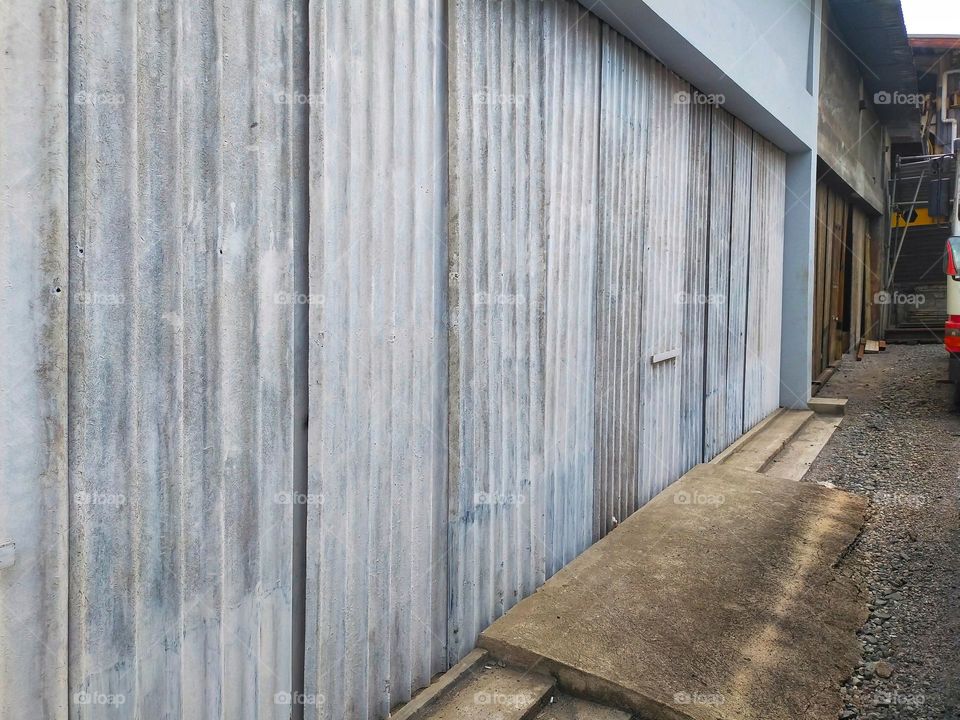 Photo of workshop door closed with corrugated iron.