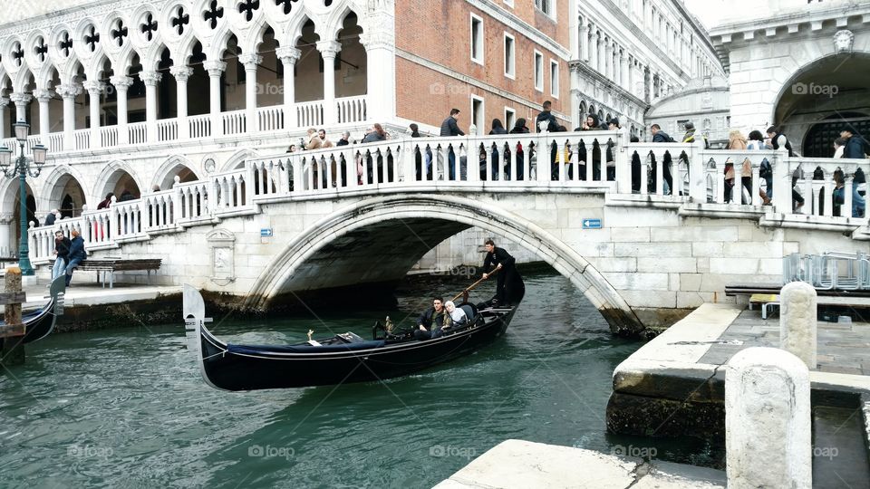 A gondola passes under the Ponte della Paglia in Venice, Italy