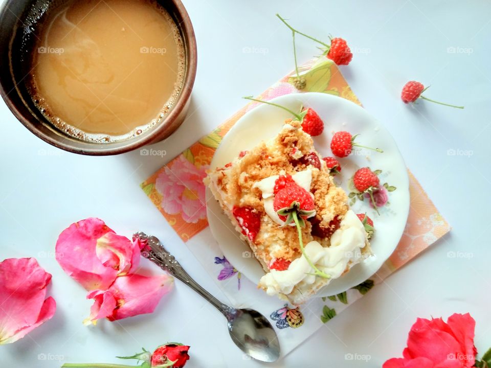 delicate creamy raspberry cake, coffee and a bouquet of roses