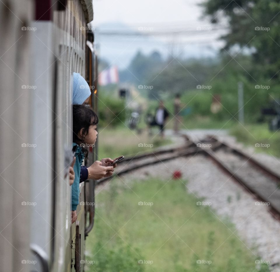 Cute girl and her mom wait to see a train