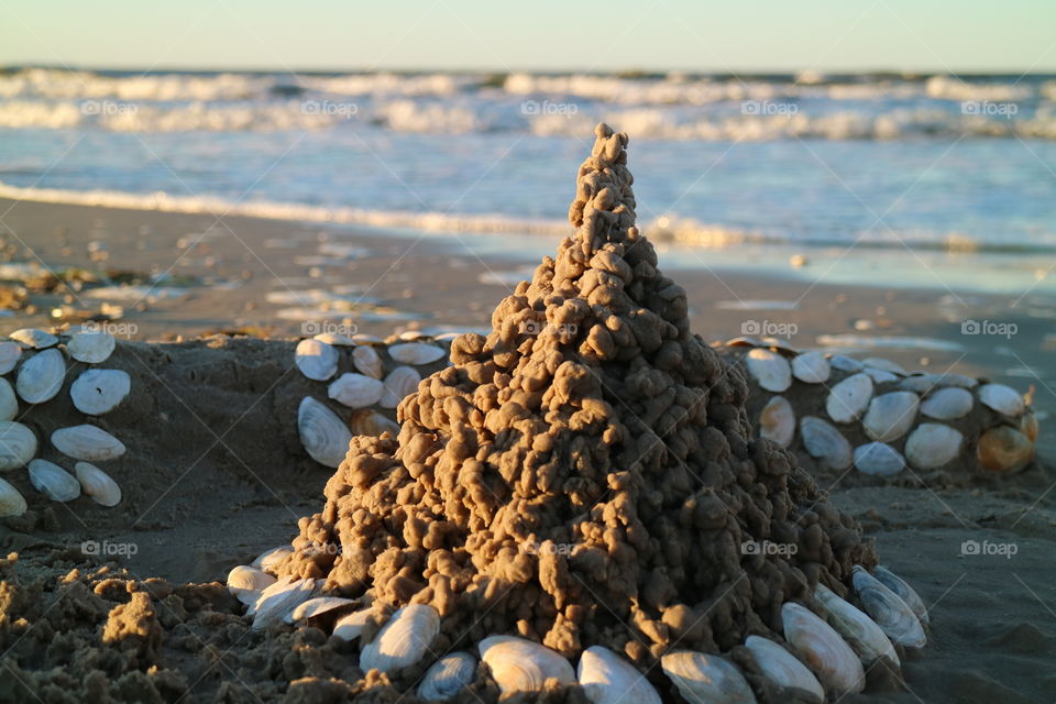 Sand castle with shells on the beach of Karlshagen on the German island Usedom in summer
