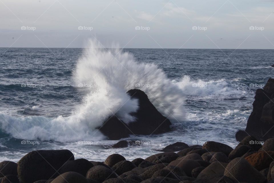 Waves crushing a rock in Iceland 