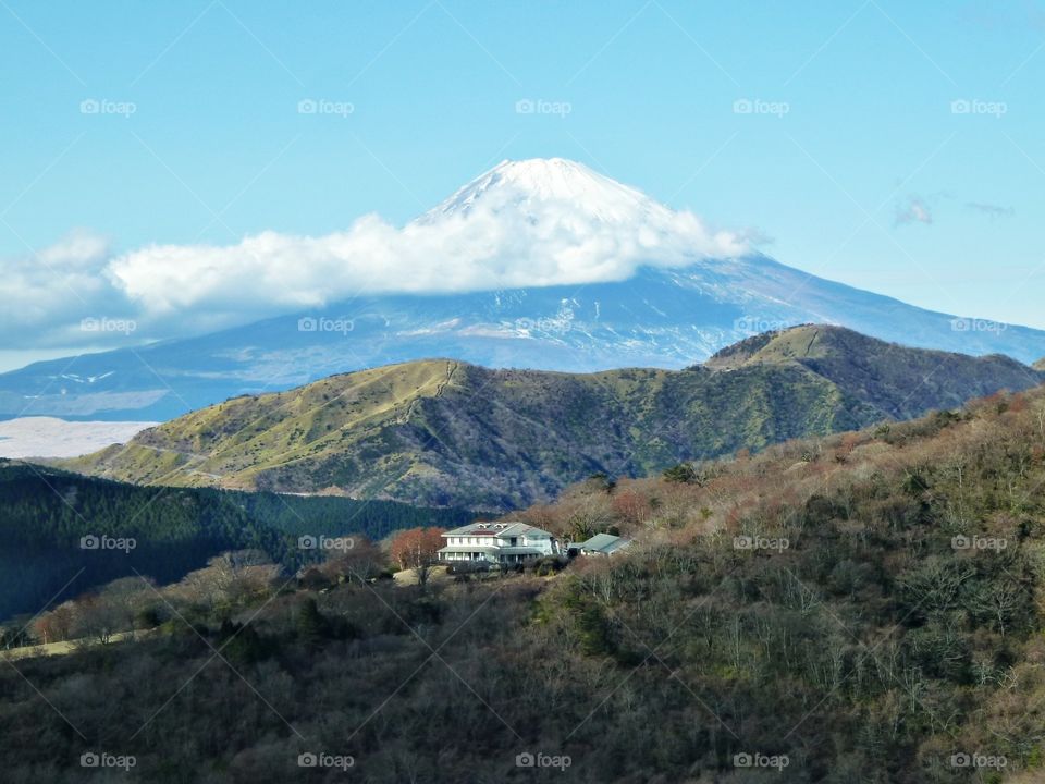 House at the top of the mountain with Mount Fuji on background