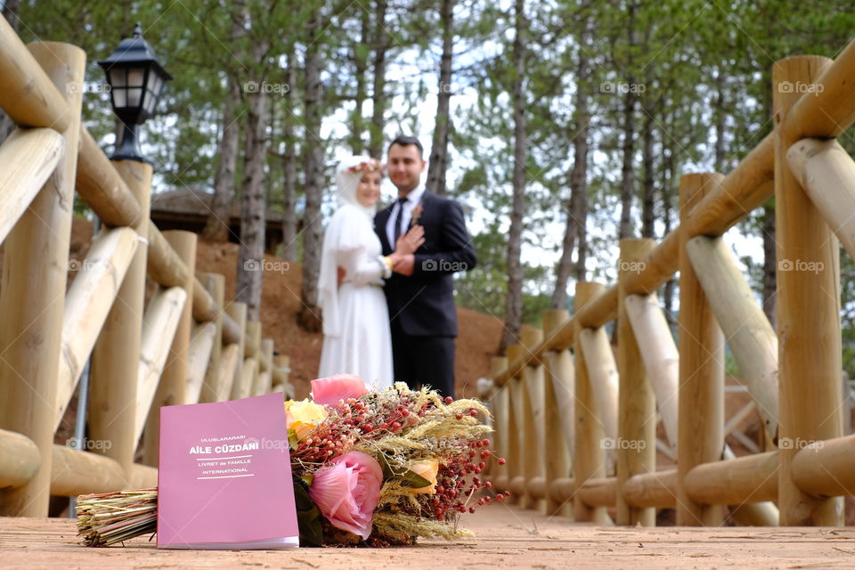 Biride and groom behind their flowers