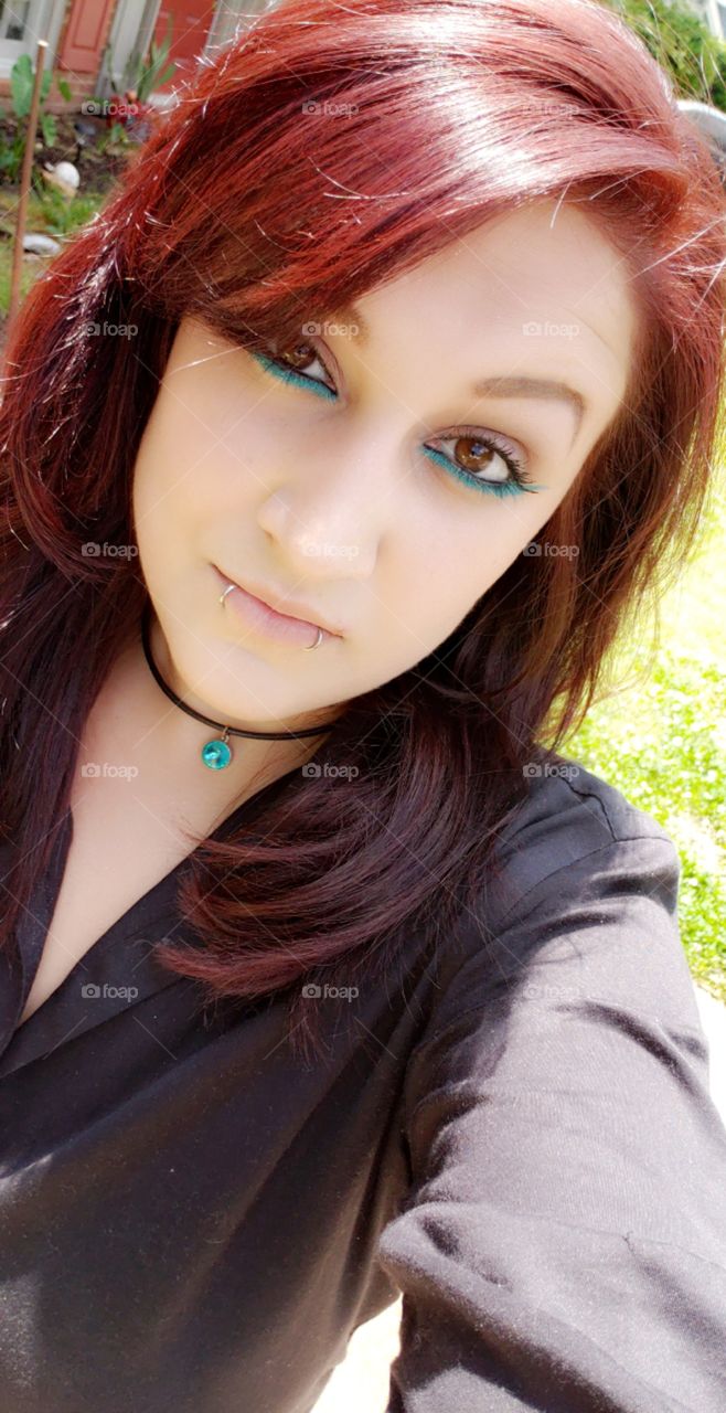 Fierce red hair with turquoise eyeliner