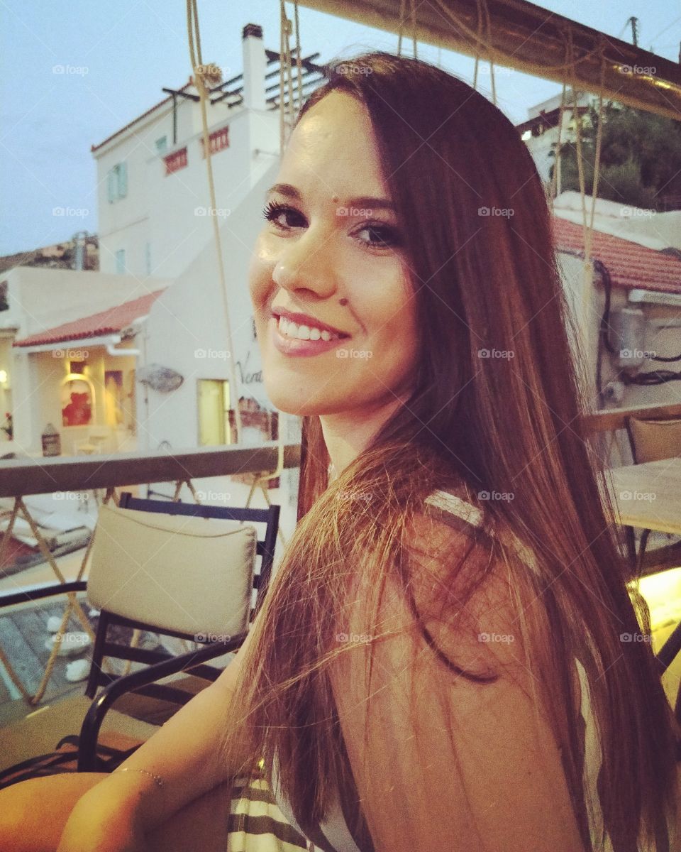 Beautiful woman outdoors in the summer in a Greek island