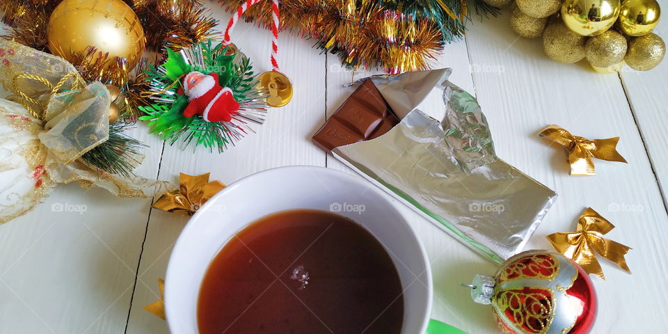 cup of tea and Lviv chocolate on the background of Christmas decorations