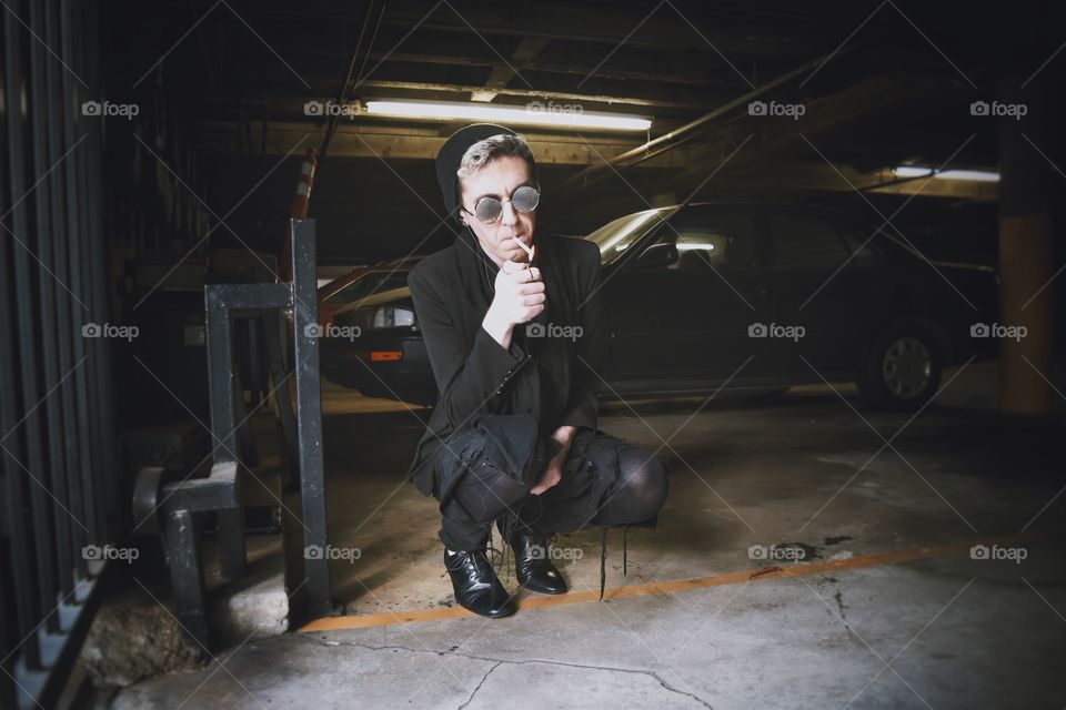 Kneeling smoking and trying to relax.