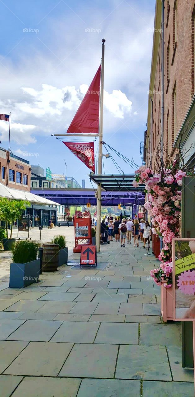 Walking through the South Street Seaport Promenade in NYC by the piers 