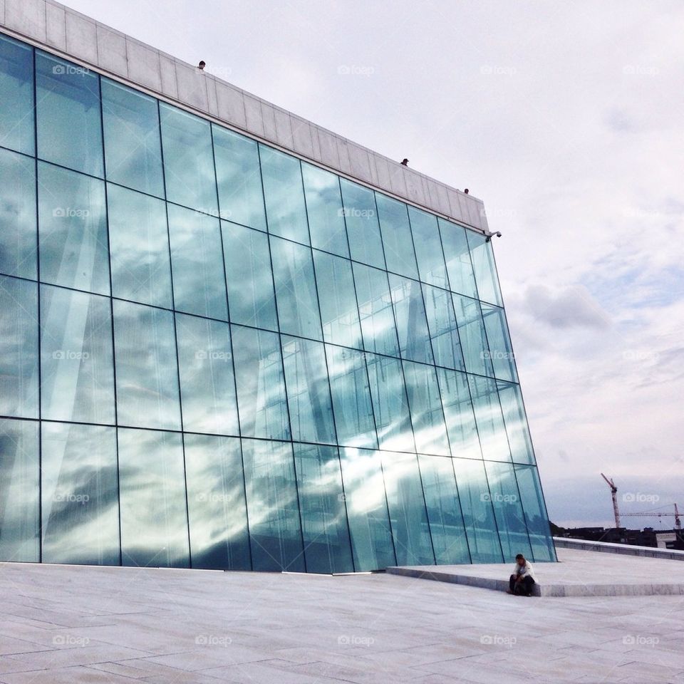 A person sitting near the building