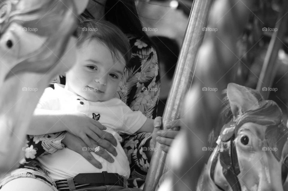 my nephew Frankie, enjoying time with mum on the carousel