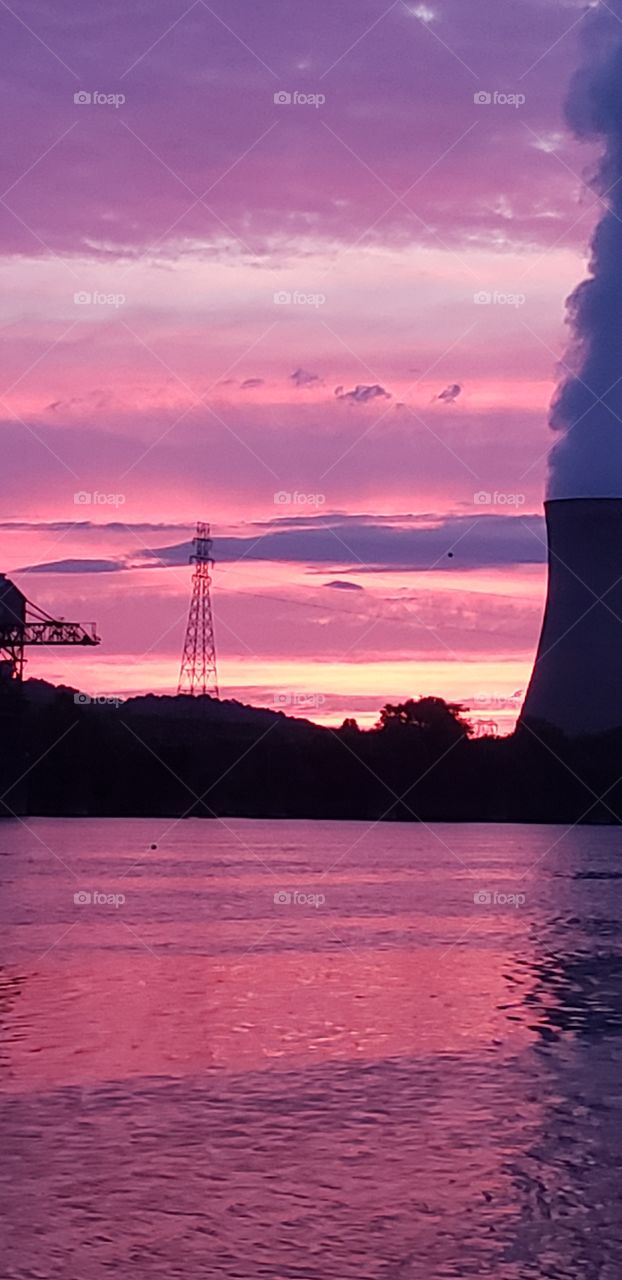sunset on the river power plant